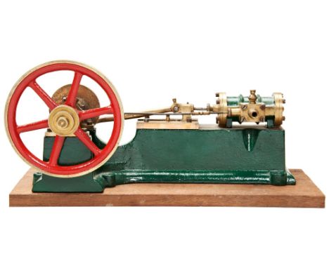 AN ENGINEERED MODEL OF A HORIZONTAL STEAM ENGINE&nbsp;on a cast iron base with brass flywheel and fittings, painted in green 