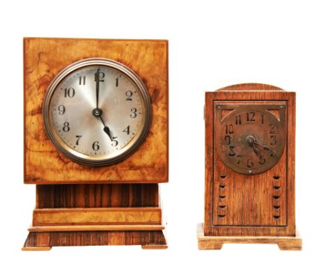 A WALNUT CLOCK, C1930 ON A STEPPED BASE&nbsp;and a small Continental Arts &amp; Crafts oak mantel clock with a stylised brass