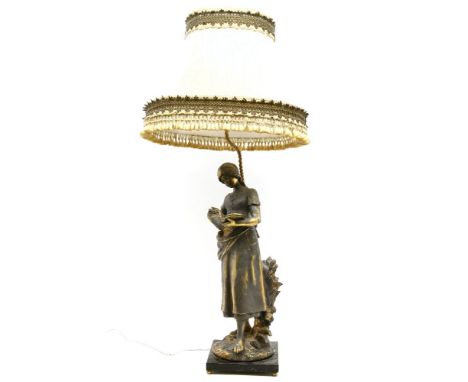 A gilt spelter figural table lamp of a girl reading a book, on a marble base, 90cm high overall