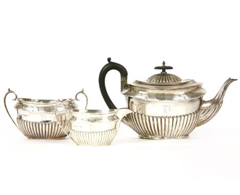 A silver three piece tea set, to include teapot, sugar bowl and milk jug, by Walker &amp; Hall, Sheffield, 1890