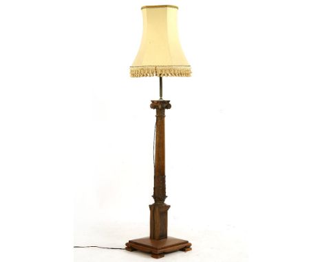 A walnut standard lamp, with a carved and turned column on a square base with shade, lamp 150cm high