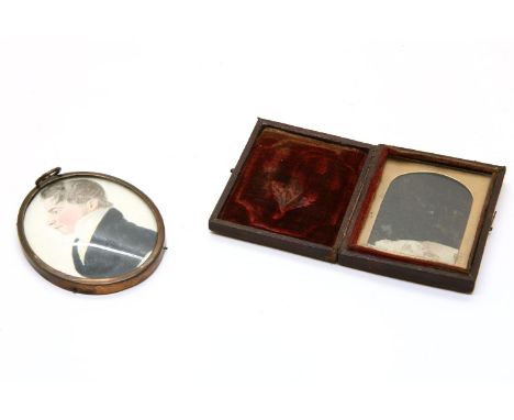 A portrait miniature of a man, oval on paper, inscribed verso 'painted by W.C.? 1824, and an embossed leather portrait case
