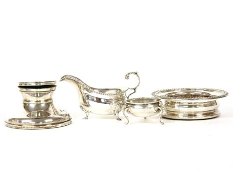 A collection of silver items to include a wine coaster by Harrods Ltd (Richard Woodman Burbridge), London, 1960, a sauce boat