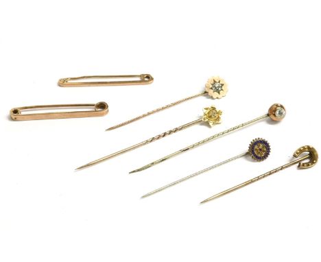 A collection of gold stick pins and two bar brooches, to include a single stone star mounted stick pin, marked 15ct (pin 9ct)