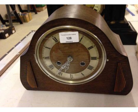 An oak wood mantle clock.