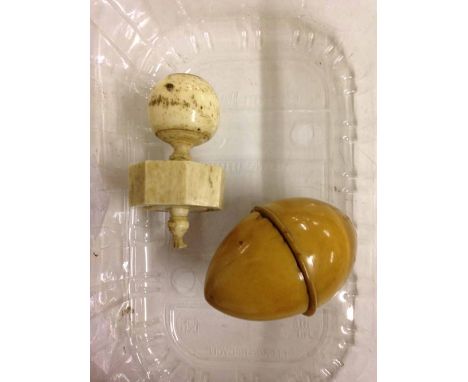 A treen, egg-shaped thimble case with a bone spinning top.