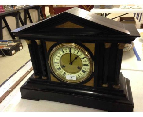 An ebonised wood Palladian style mantle clock.