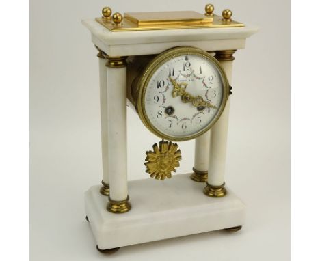 Tiffany and Co France Marble and Brass Mantle Clock. Porcelain dial marked "Tiffany & Co., France" with decorative hands and 