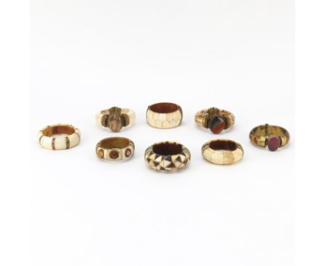 Grouping of Eight (8) Indian Carved Bone Bangle Bracelets. All mounted with brass, seven with pin closure. Four with various 