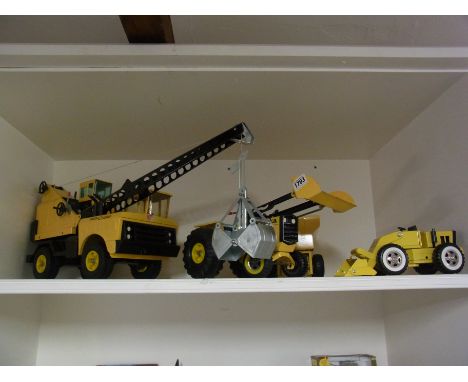 A Tonka Toy digger, tractor and trailer and smaller dumper truck 
Condition report: As new condition