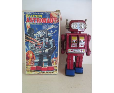 A Rotate-o-Matic Super Astronaut battery operated robot by Horikawa Japan, maroon plastic and lithographed tin plate body, bl