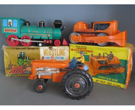 A battery operated whistling lighted piston Locomotive by Marx - boxed and in good condition - a battery operated forward and