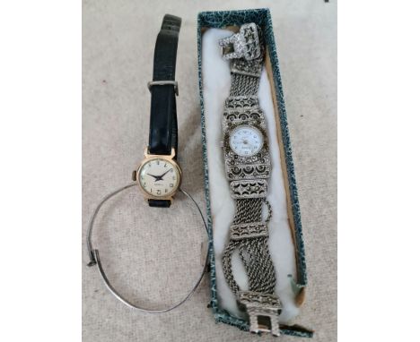 A ladies marcasite set cocktail watch and a Christening bangle marked 'Sterling Silver'.  