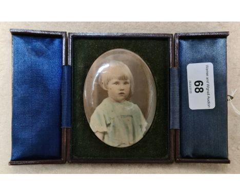 A vintage portrait of a child in leather case.  