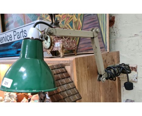 A wall mounted industrial / engineers adjustable lamp with enameled shade.  