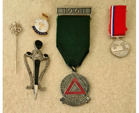 A lot of miscellaneous collectables including a 1961 Safe Driving medal, a white metal tie pin, "The Cold War - 1945 - 1991" 