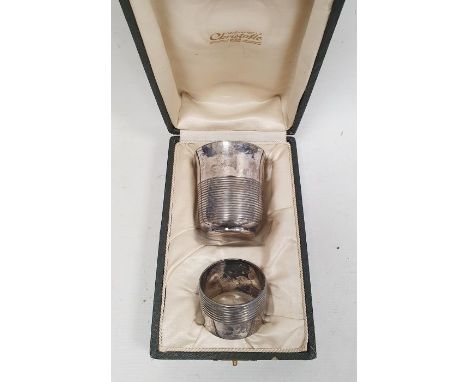 A Christofle silver-plated christening set, mid-century, comprising a cup of beaker form with reeded exterior and a napkin ri