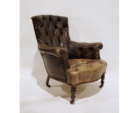 Late 19th century brown leather button-back armchair on turned supports to castors 