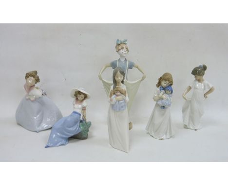 Six Nao figures, printed brown marks comprising two figures of girls cuddling dolls, a girl dancing in a white dress, another