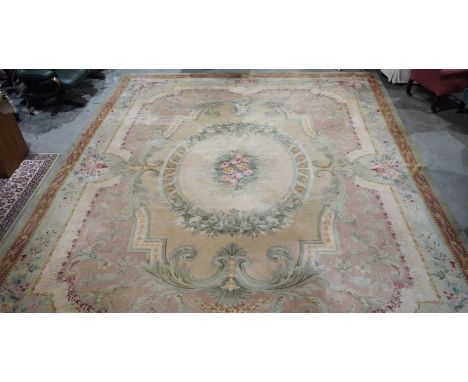 Large Aubusson style cream ground carpet with central floral motif surrounded by floral decoration and floral border 458 x 36