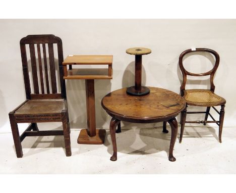 20th century mahogany circular table on cabriole legs, two oak slat back 20th century chairs, a large bobbin, cane seated cha