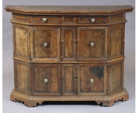 A late 17th/early 18th century Italian walnut credenza fitted two short drawers above cupboards enclosed by four panel doors,