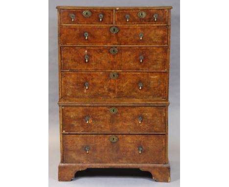AN EARLY 18TH CENTURY WALNUT CHEST-ON-CHEST with all-over cross banding, fitted two short &amp; five long graduated drawers w
