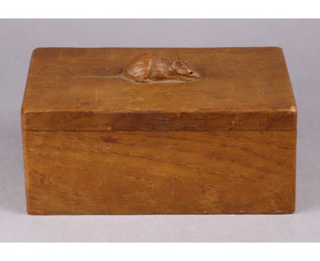 A Robert “Mouseman” Thompson oak rectangular box &amp; cover, with adzed surface, the carved mouse forming a handle, 19cm wid