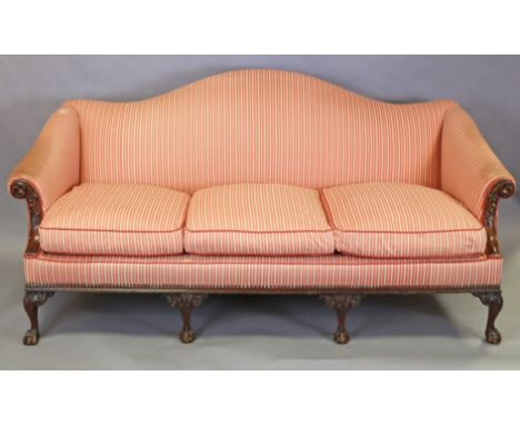 A Victorian Chippendale-style mahogany frame camel-back sofa with carved decoration, upholstered in red &amp; white striped f