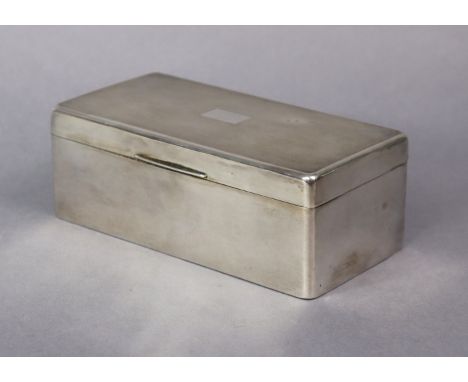 A George V silver rectangular cigarette box with engine-turned hinged lid &amp; wood lined interior, 17.5cm wide; Birmingham 