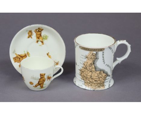 A Victorian porcelain large mug with transfer-printed map of Somersetshire &amp; painted floral spray, with gilt rim &amp; ha