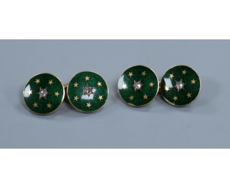 A pair of yellow metal, enamel and diamond set cuff links.