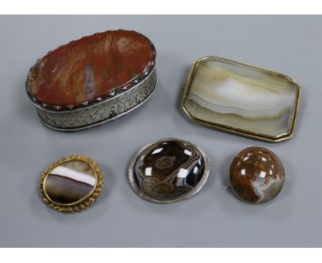 A Georgian white metal and jasper hardstone oval snuff box and four hardstone brooches including banded agate.