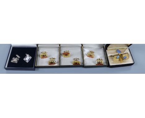 A pair of pierced silver cufflinks and four other pairs of metal cufflinks including opal pair with tie clip.