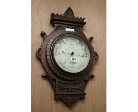 A late Victorian carved oak barometer W.35cm