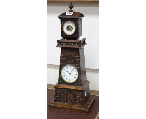 A late Victorian carved oak "Lighthouse " clock barometer by Frank Flower of St James