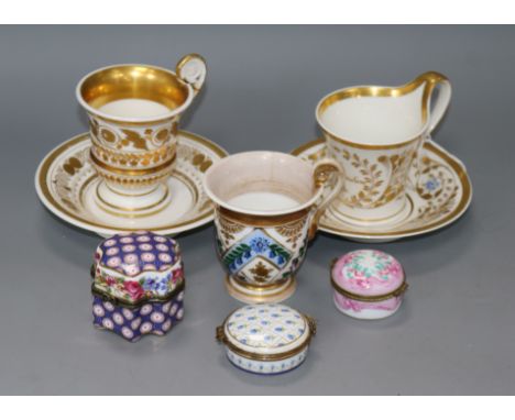 Two early 19th century Empire style coffee cups and a Berlin cup and saucer, and three porcelain trinket boxes