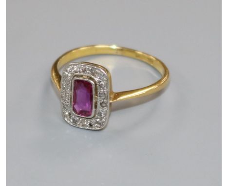 A 1920's/1930's 18ct gold and platinum ruby and diamond tablet ring, size M.