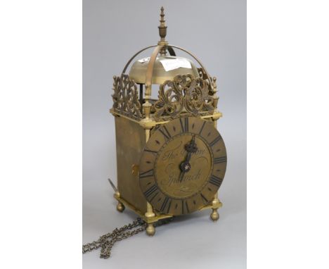 An early 20th century brass lantern clock, by Thos. Moore, Ipswich, with weight and pendulum. height 39cm