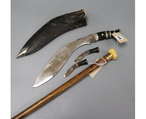 A malacca walking cane and a kukri knife in leather sheath the cane with presentation gilt band and carved ivory finial in th