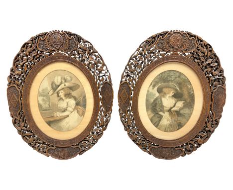 Pair of early 20th century carved and pierced Burmese hardwood frames, each of oval form carved with shaped panels, the upper