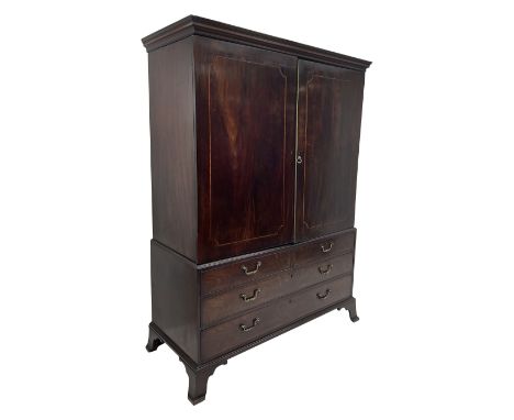 George III mahogany linen press, moulded projecting cornice over two figured doors, the interior fitted with four linen slide