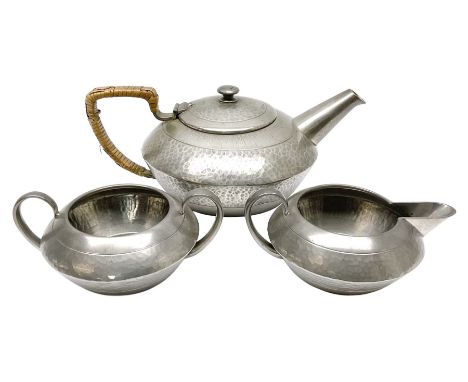 Liberty &amp; Co Tudric pewter three piece tea service, comprising teapot with woven reed handle, twin handled open sucrier, 