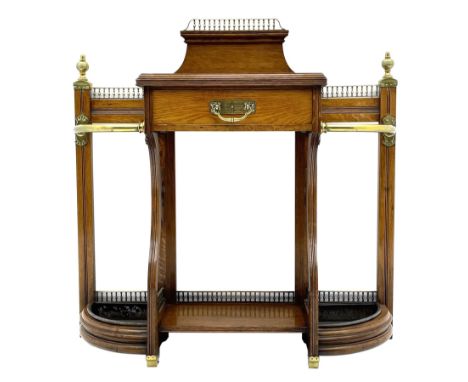 Late Victorian oak umbrella and stick hall-stand, the top fitted with brass balustrade and finials, central drawer flanked by