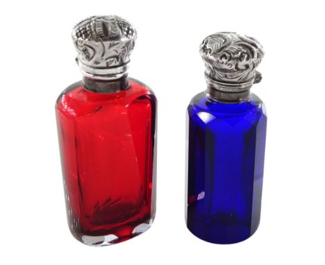 Victorian ruby glass facet cut scent bottle, the silver foliate embossed hinged cover lifting to reveal a stopper, together w