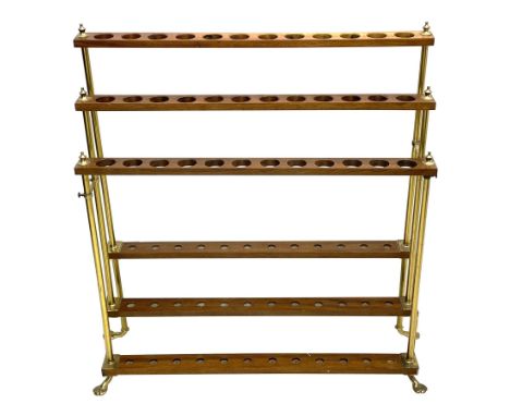 Late 20th century three tier brass and mahogany stick stand, thirty-six stick capacity, on splayed brass feet, turned finals 
