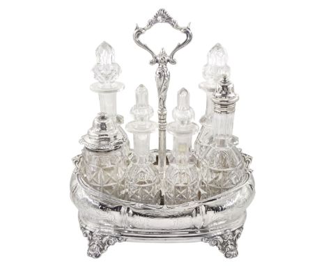 Victorian silver cruet stand, of rounded bombe form with engraved scrolling foliate decoration, the central shaped handle sup