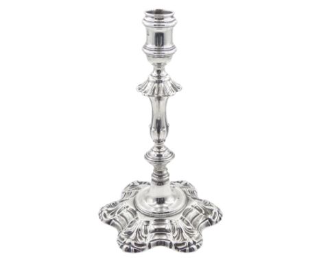 George II cast silver candlestick, the hexafoil petal base leading to a knopped stem, conforming petal shoulder and spool cap