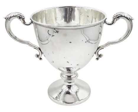 Early 20th century silver trophy cup, the plain bowl upon a circular spreading foot, with twin acanthus capped scroll handles