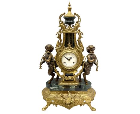 20th century continental gilt metal Lyre mantle clock on a raised plinth with paw feet and variegated green marble base, with